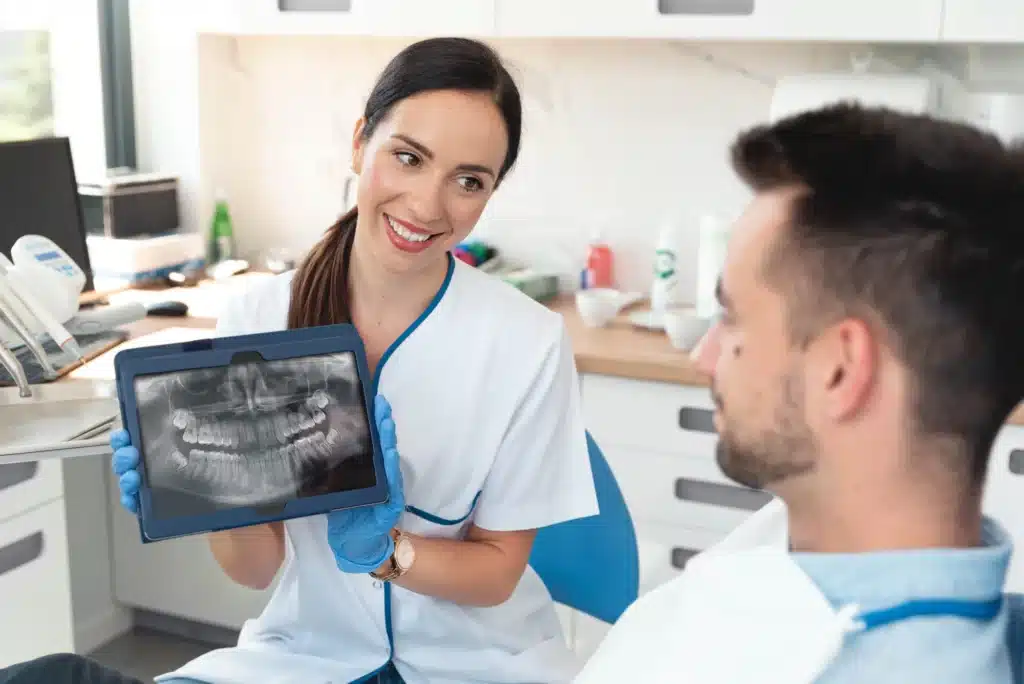 Man and his xray result examined by a dentist in brownstown