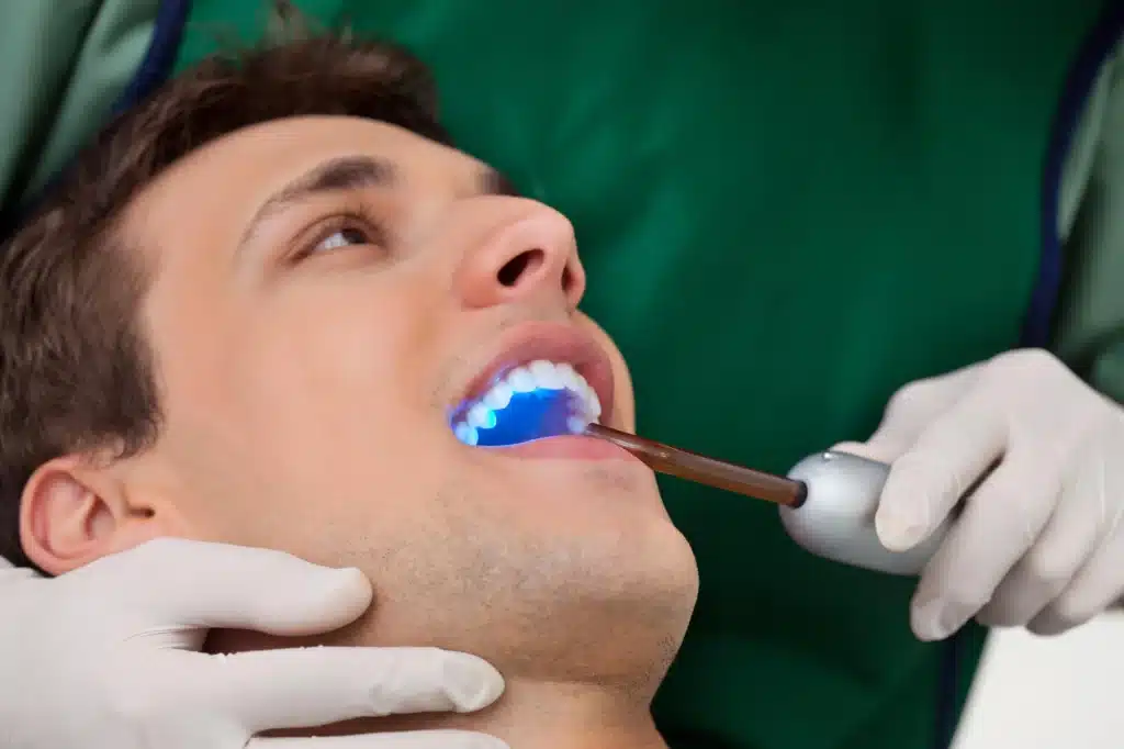 Man undergoing treatment by a dentist in woodhaven mi