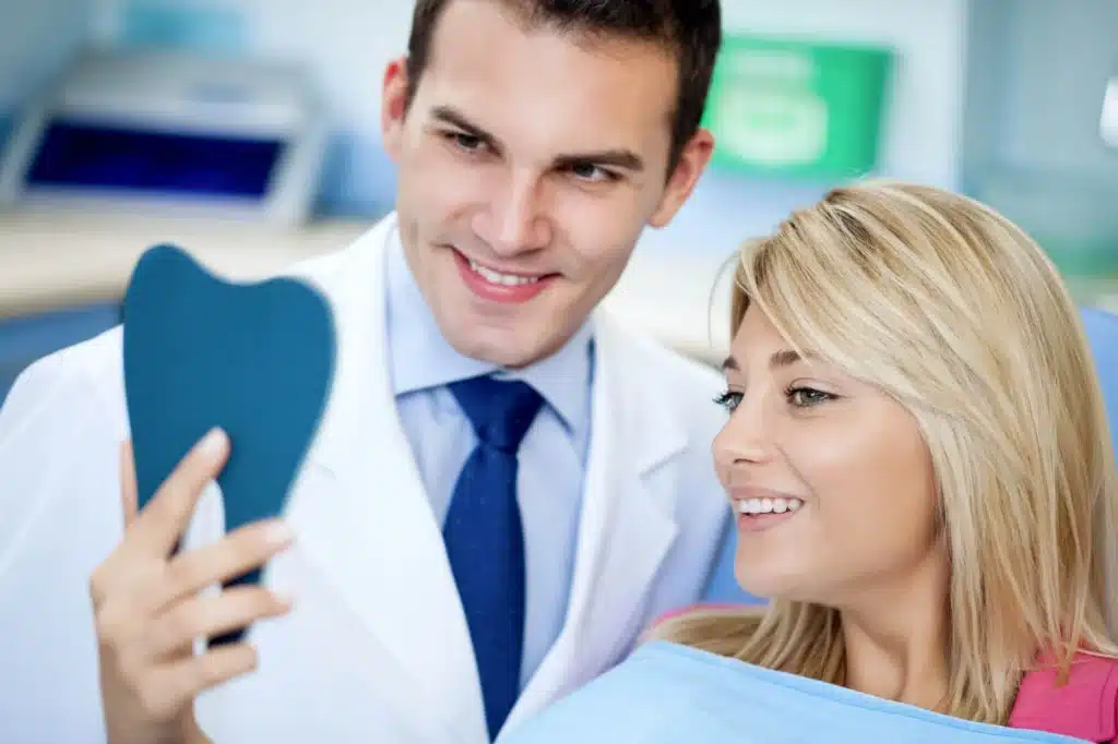 Woman checking her white teeth brownstown cosmetic dentist